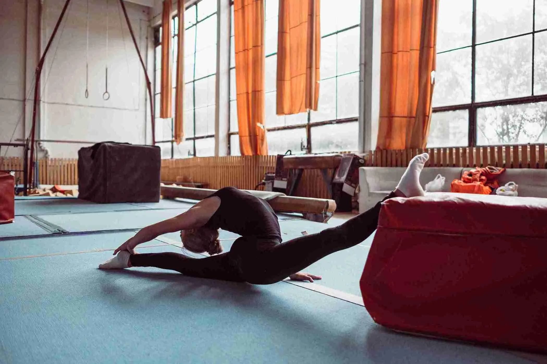 long-shot-woman-exercising-gymnastics-olympics_11zon