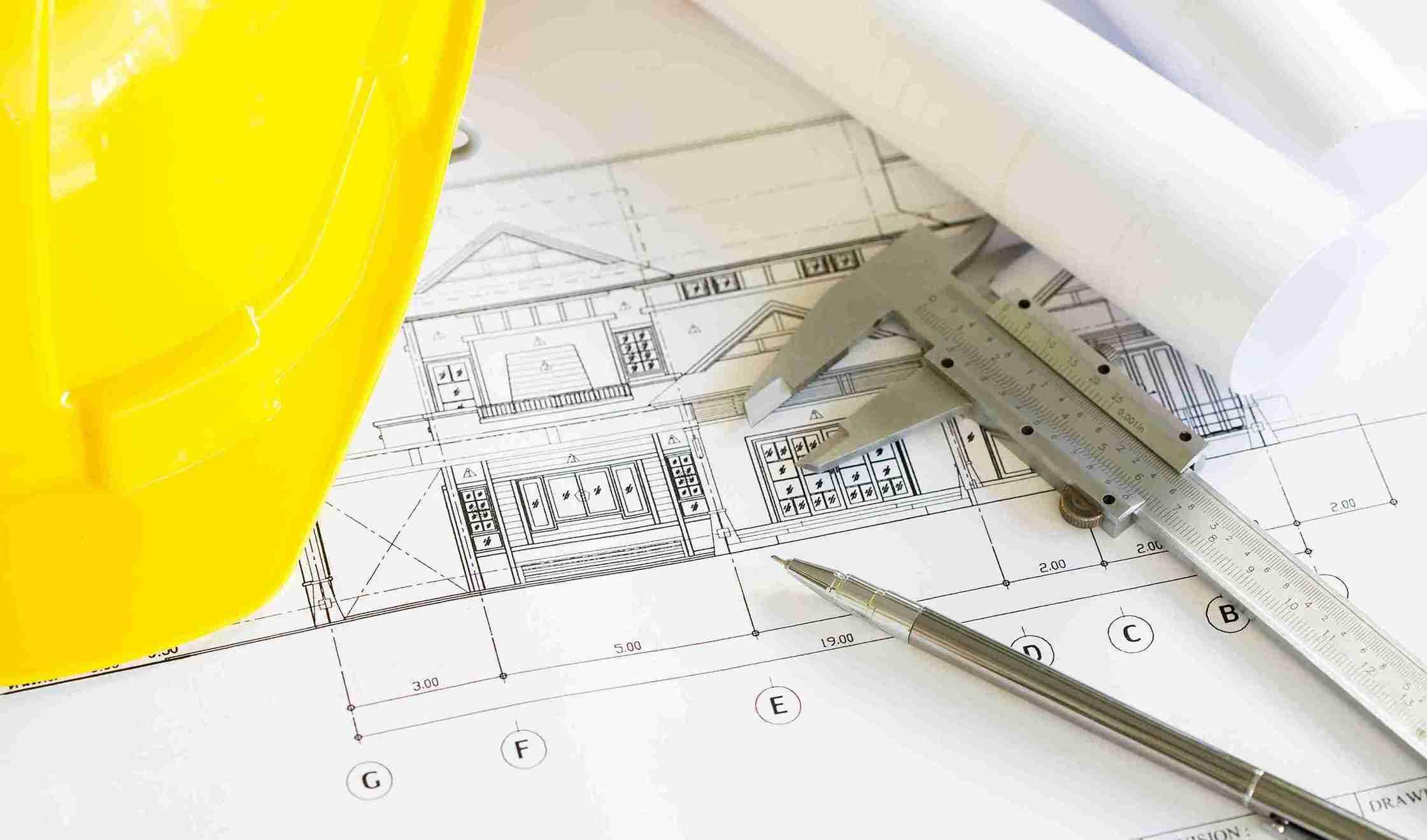 construction-plans-with-yellow-helmet-drawing-tools-bluep_11zon